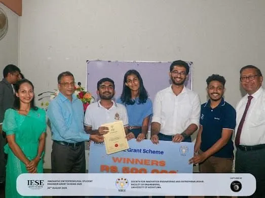 The BSFix team receiving the IESE grant certificate and winners' board