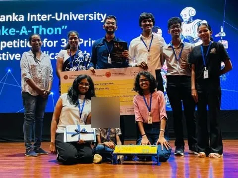 The Make-A-Thon winning team on stage with their certificate and the 3D-printed tactile keyboard